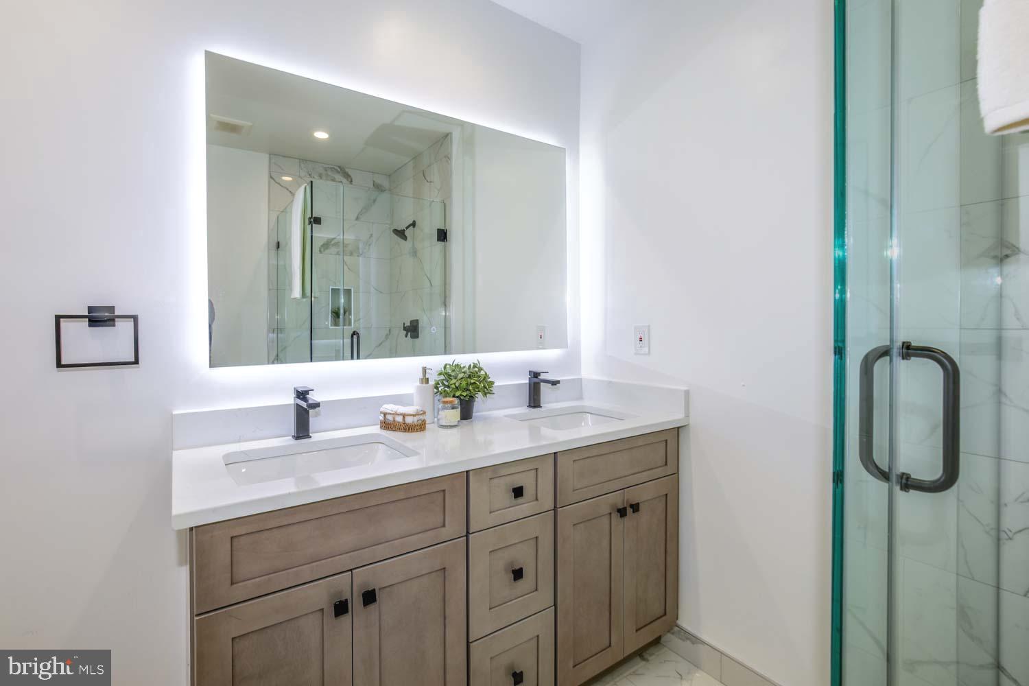 424 Taylor Street Northwest, Unit 1 Washington, DC 20011 - Photo 38 of 53 a bathroom with a granite countertop sink vanity and mirror