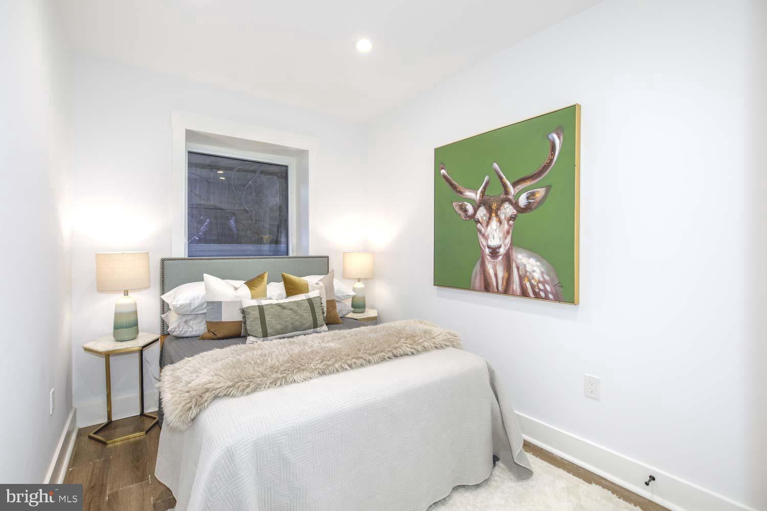 424 Taylor Street Northwest, Unit 1 Washington, DC 20011 - Photo 40 of 53 a bedroom with bed and wall painting