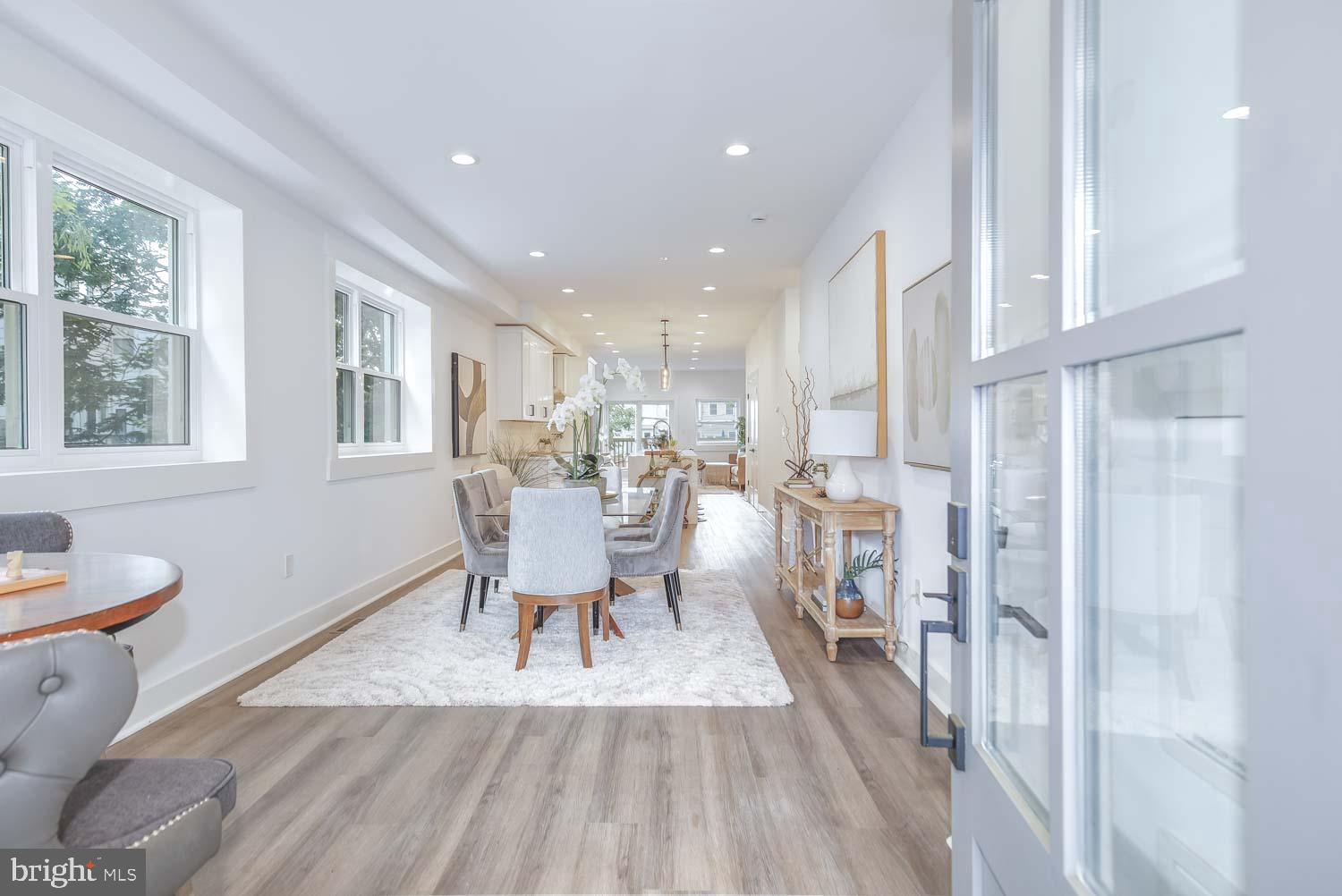 424 Taylor Street Northwest, Unit 1 Washington, DC 20011 - Photo 4 of 53 a dining room with a table chairs and a kitchen view