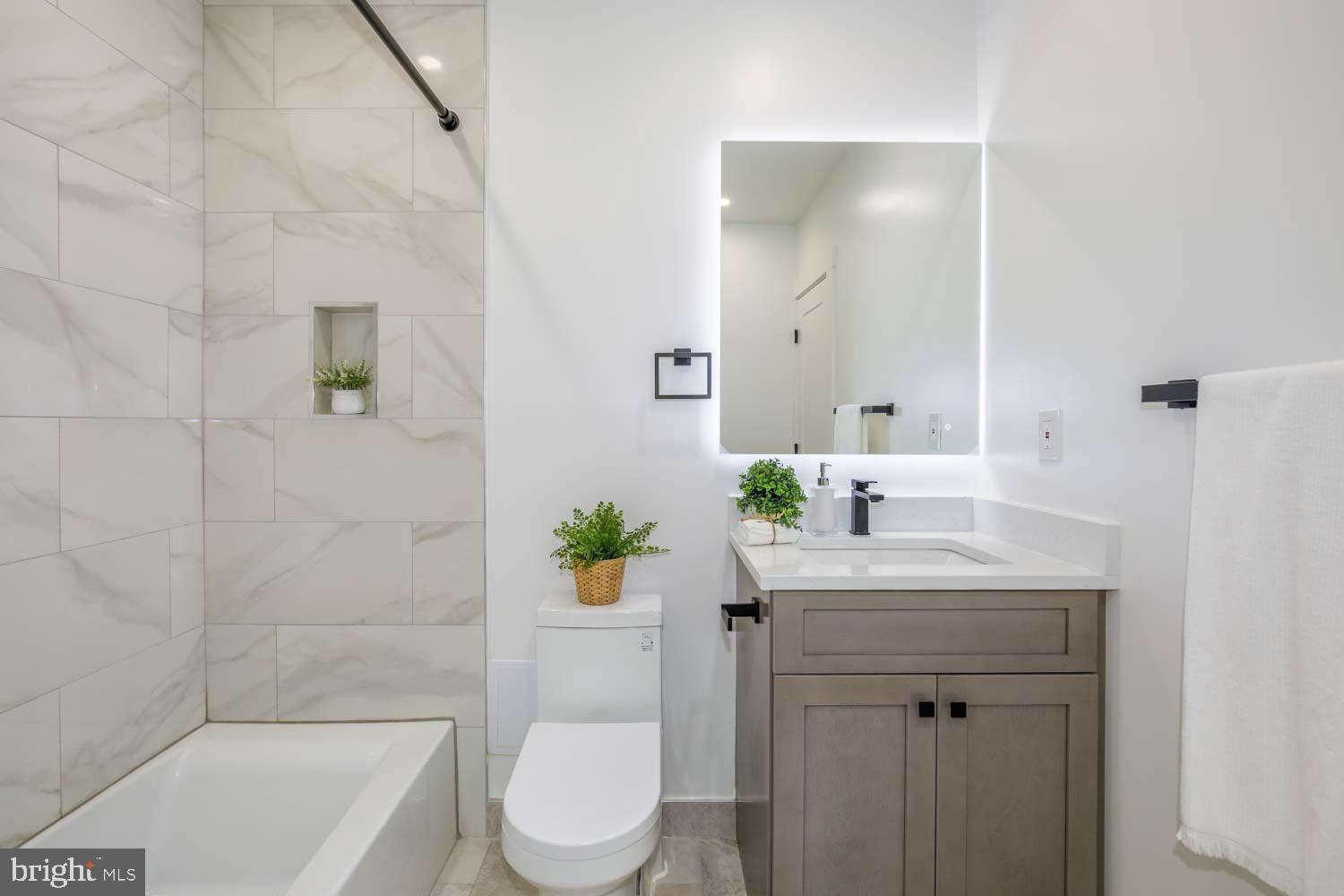 424 Taylor Street Northwest, Unit 1 Washington, DC 20011 - Photo 43 of 53 a bathroom with a sink a toilet a mirror and shower
