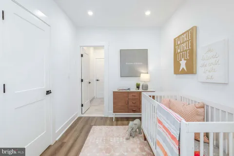 a front view of a multi story residential apartment building with yard and parking space