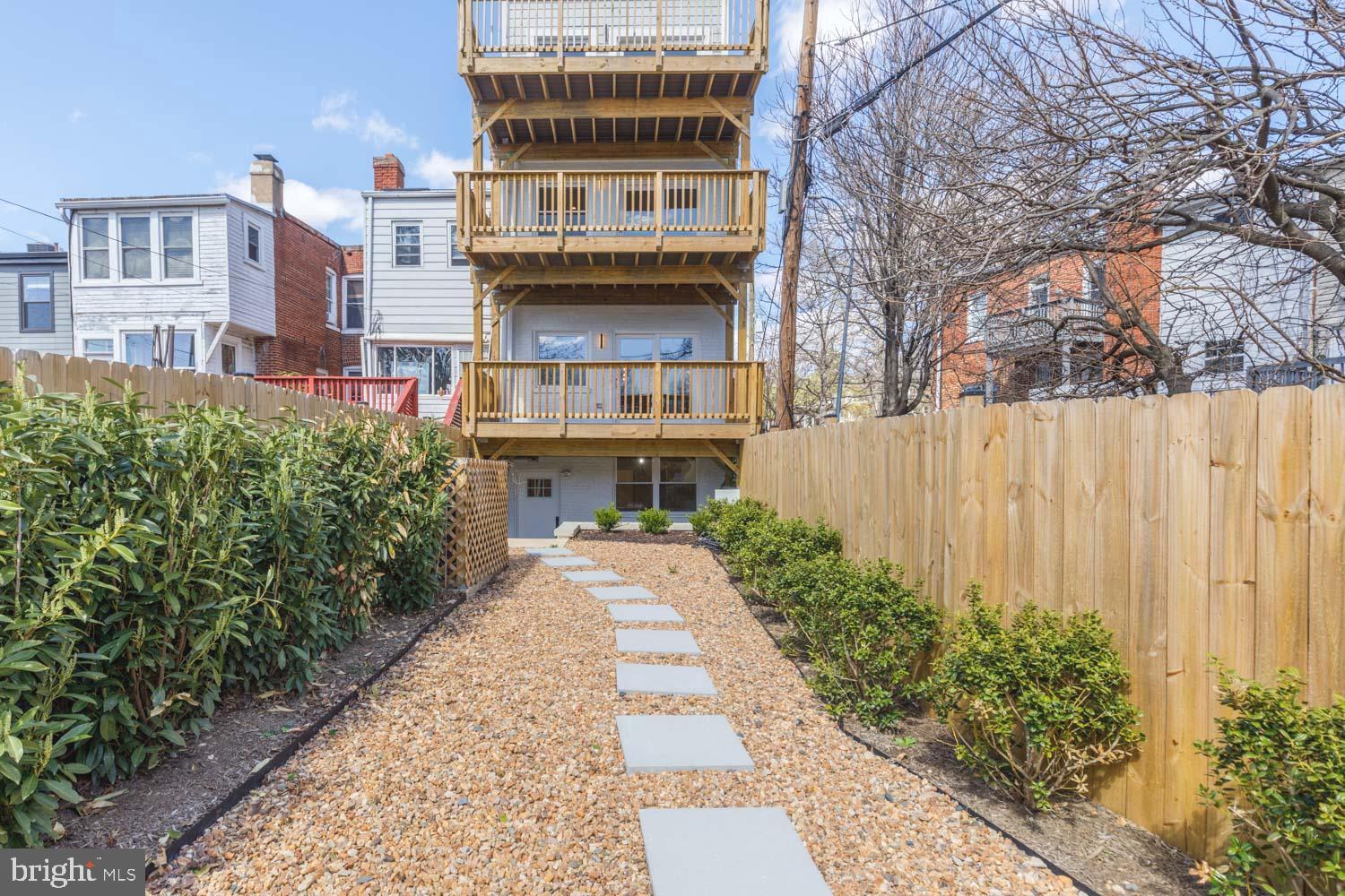 424 Taylor Street Northwest, Unit 1 Washington, DC 20011 - Photo 51 of 53 a front view of a multi story residential apartment building with yard and parking space