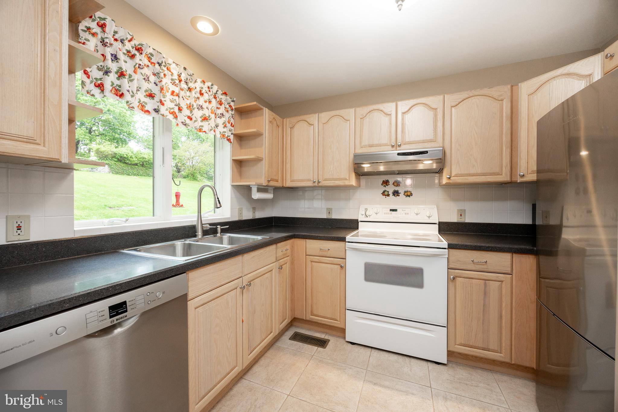 237 Poplar Street Spring City, PA 19475 - Photo 11 of 36 a kitchen with granite countertop white cabinets and white appliances