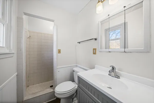 a bathroom with a sink toilet and shower