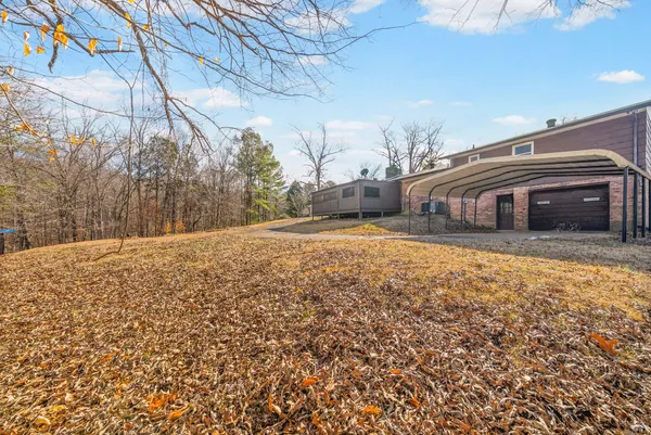 a view of house with backyard and tree