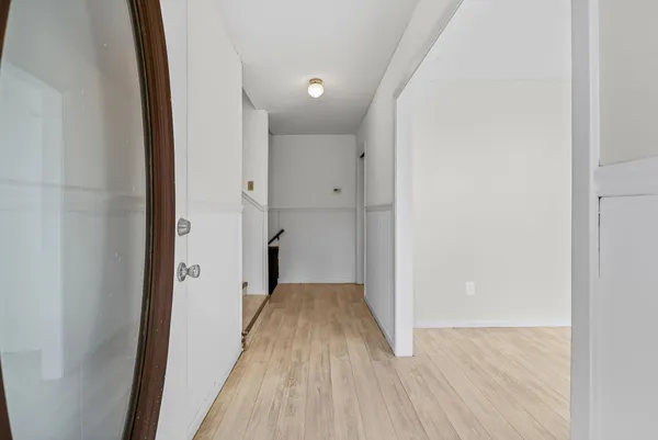 a view of a hallway with wooden floor