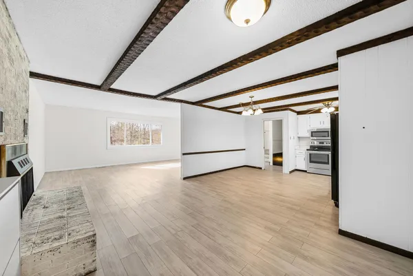 a view of a room with wooden floor