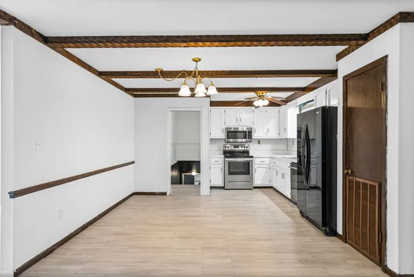 a kitchen with stainless steel appliances a refrigerator and a stove top oven