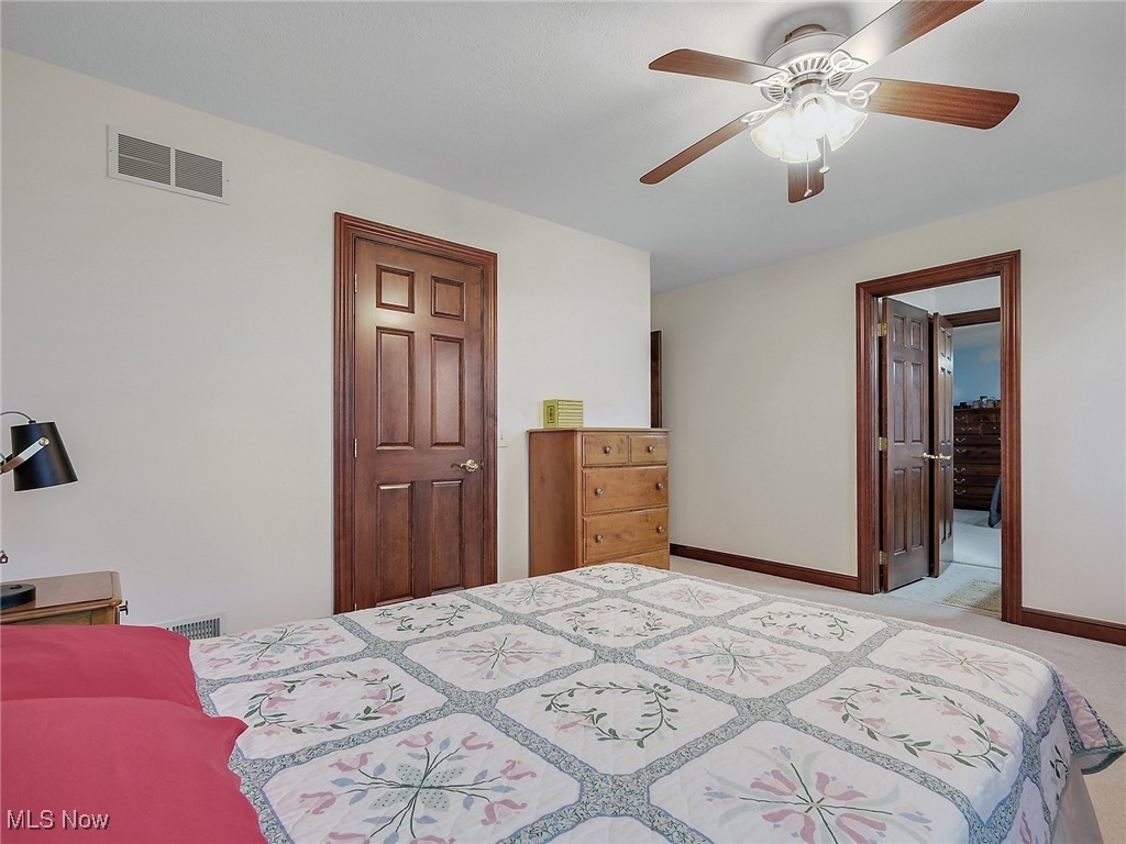 9659 Yoder Road Southwest Sugarcreek, OH 44681 - Photo 24 of 39 Bedroom featuring light colored carpet and ceiling fan