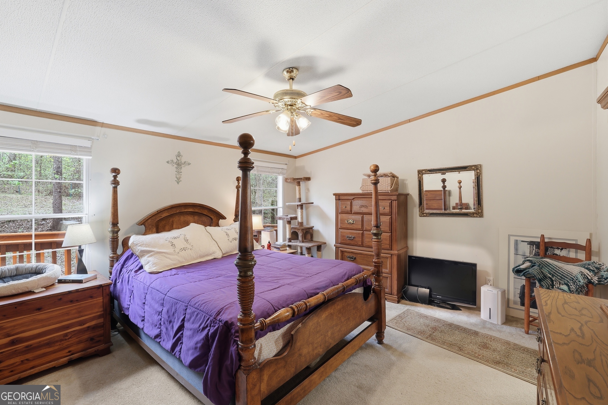 2533 McFarlin Bridge Road Carnesville, GA 30521 - Photo 15 of 37 a bedroom with a bed a table and a fireplace