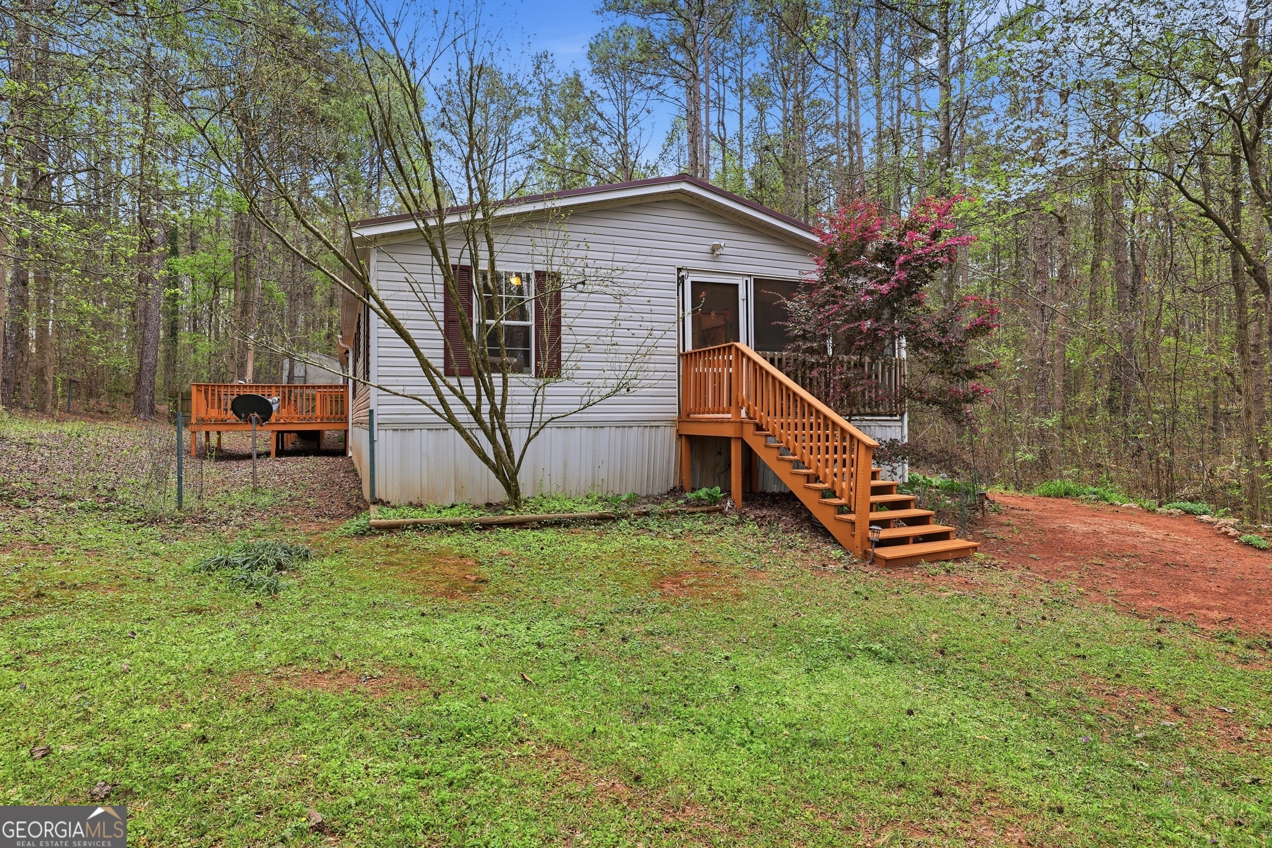 2533 McFarlin Bridge Road Carnesville, GA 30521 - Photo 26 of 37 a view of backyard of house with deck and outdoor seating