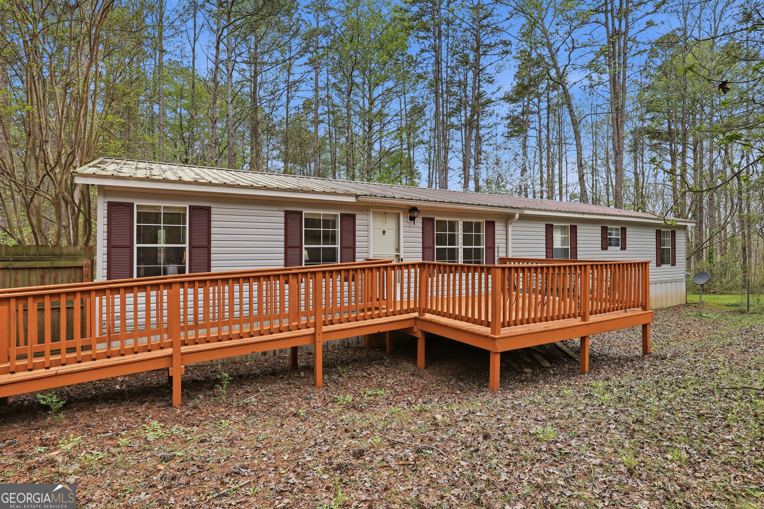 2533 McFarlin Bridge Road Carnesville, GA 30521 - Photo 3 of 37 a backyard of a house with a deck and a yard
