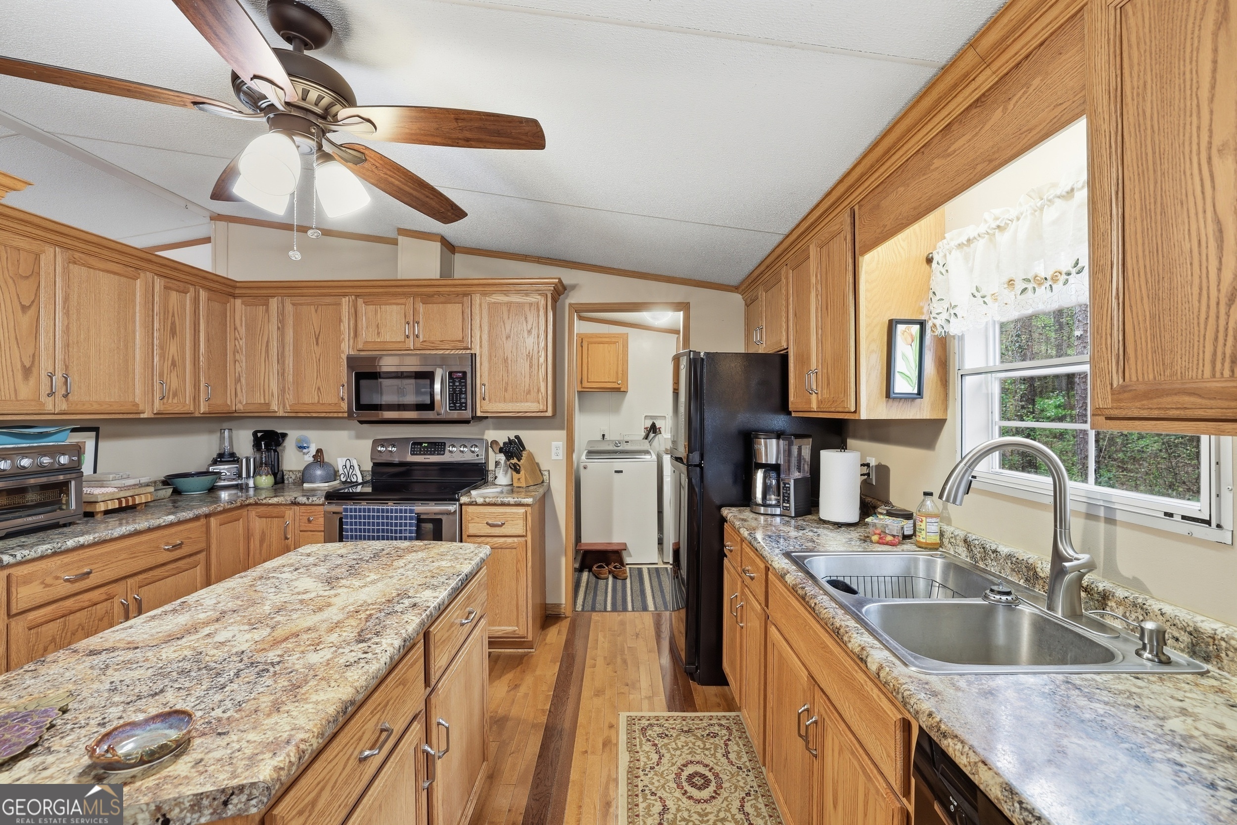 2533 McFarlin Bridge Road Carnesville, GA 30521 - Photo 10 of 37 a kitchen with stainless steel appliances granite countertop a sink stove and refrigerator