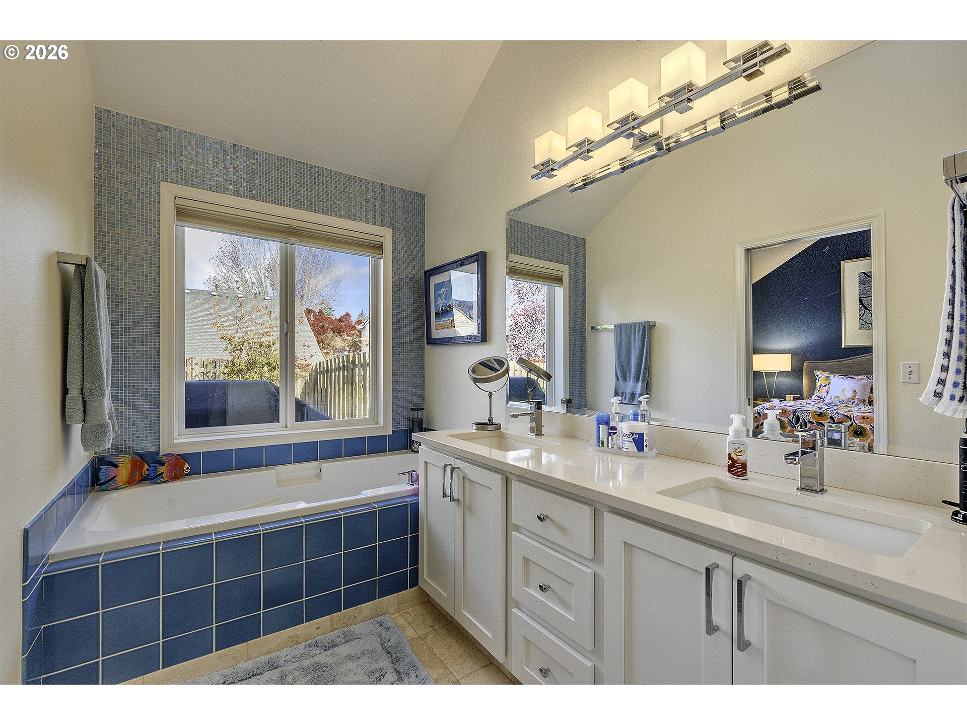 16761 Northwest Stoller Drive Portland, OR 97229 - Photo 14 of 35 a spacious bathroom with a double vanity sink a mirror and a bathtub