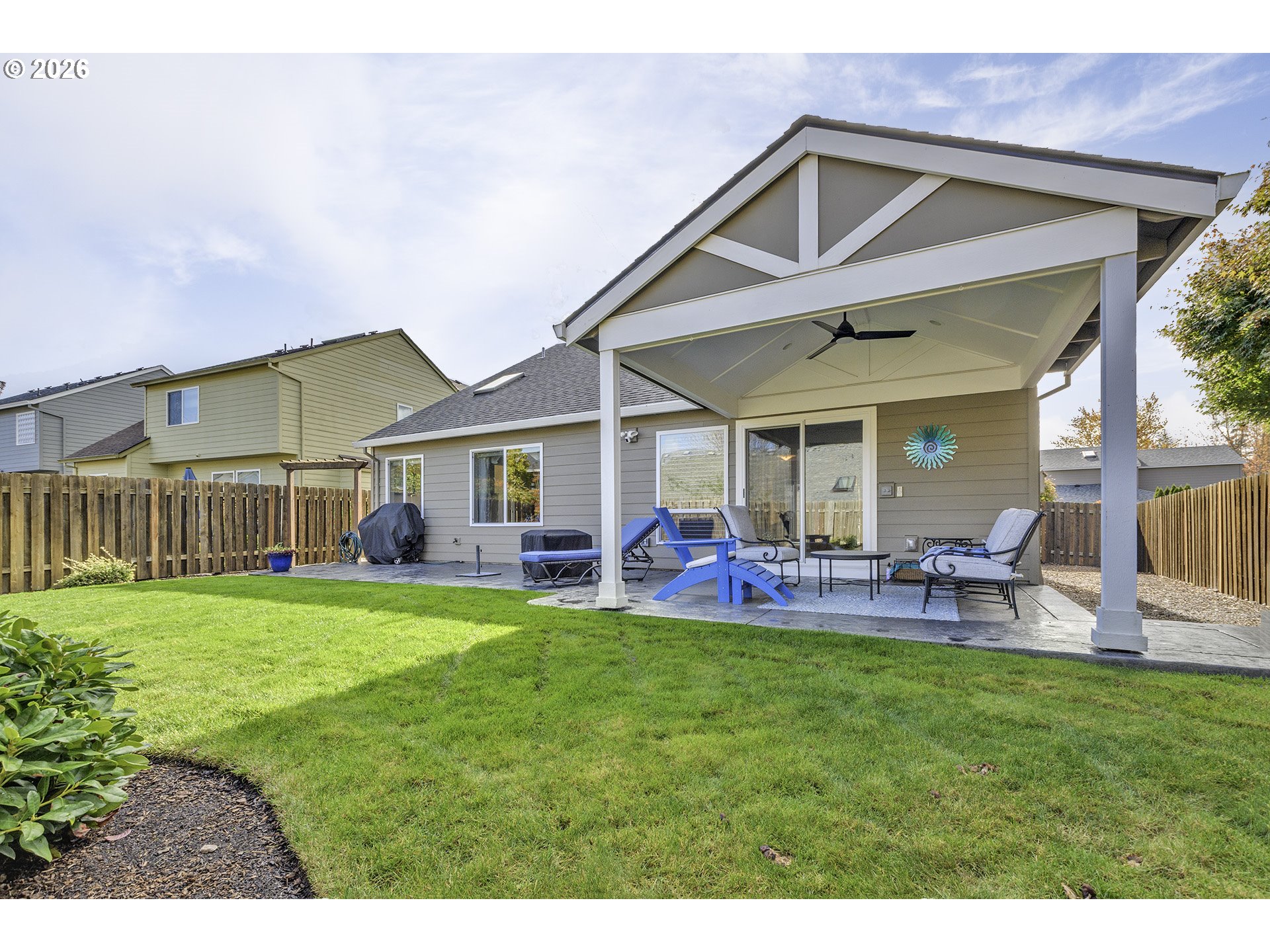 16761 Northwest Stoller Drive Portland, OR 97229 - Photo 23 of 35 a front view of a house with a yard table and chairs