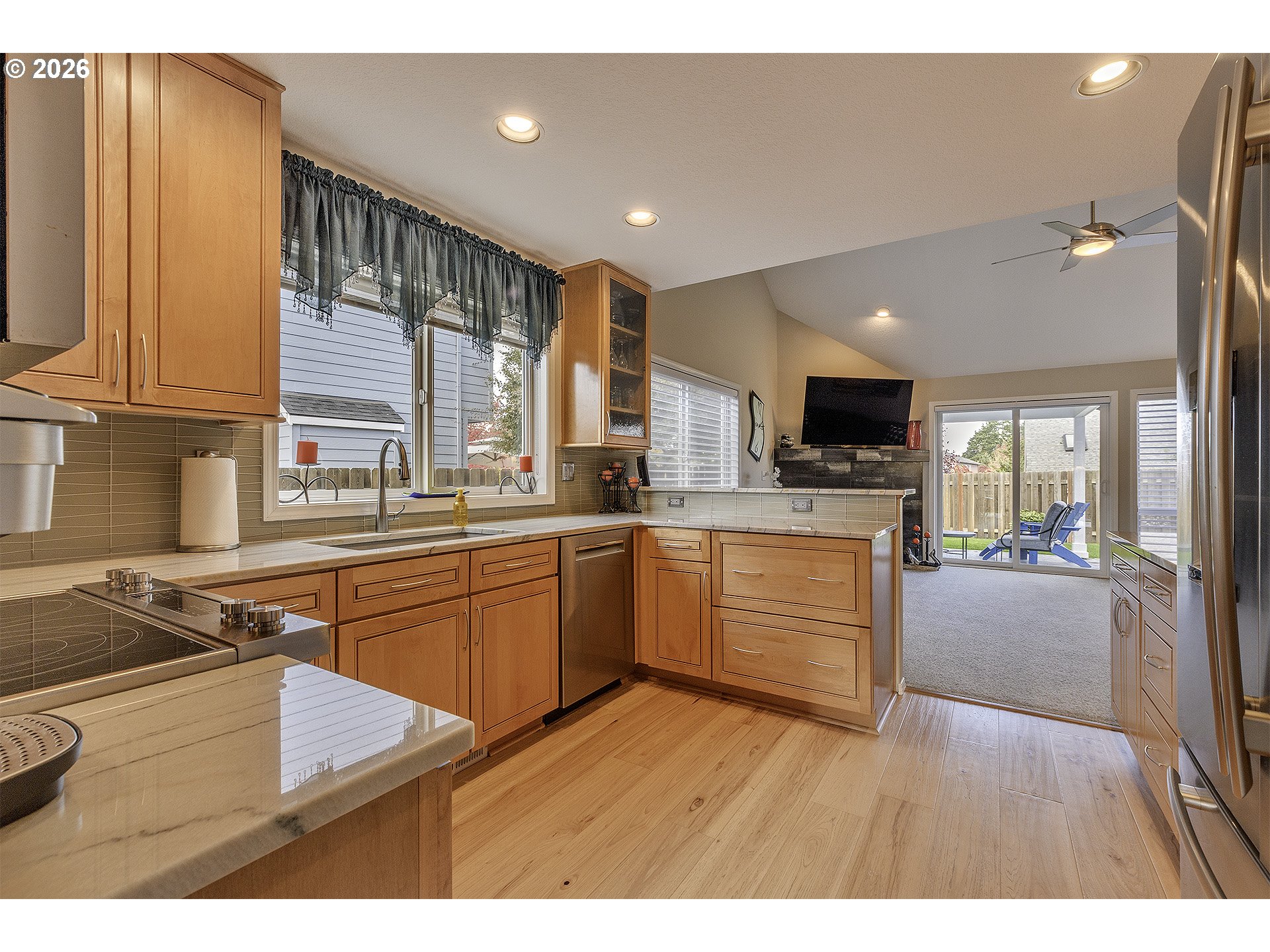 16761 Northwest Stoller Drive Portland, OR 97229 - Photo 10 of 35 a kitchen with kitchen island granite countertop a sink cabinets and wooden floor
