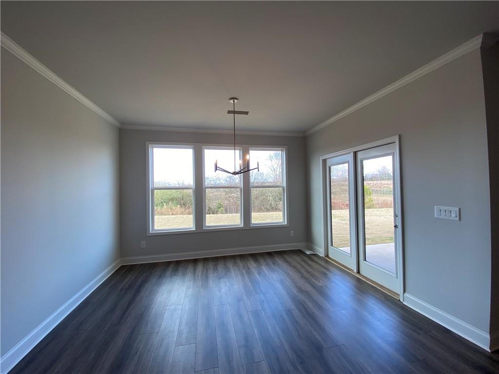 166 Montview Drive Jefferson, GA 30549 - Photo 11 of 52 an empty room with wooden floor and windows
