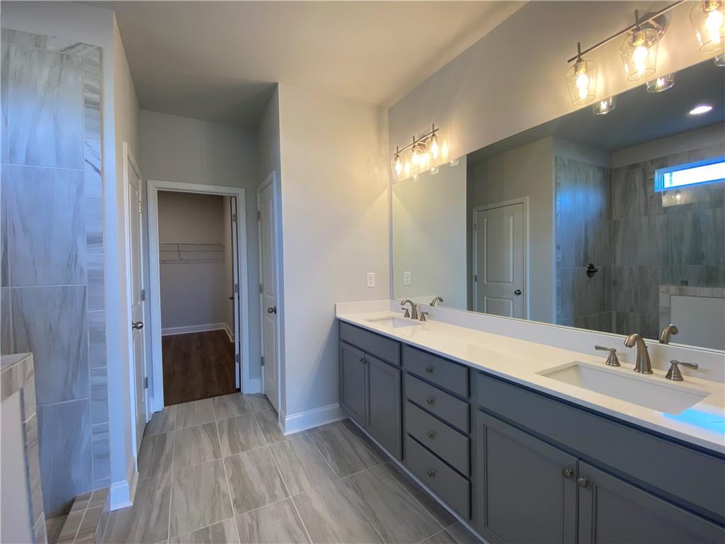 166 Montview Drive Jefferson, GA 30549 - Photo 14 of 52 a bathroom with a double vanity sink and a mirror