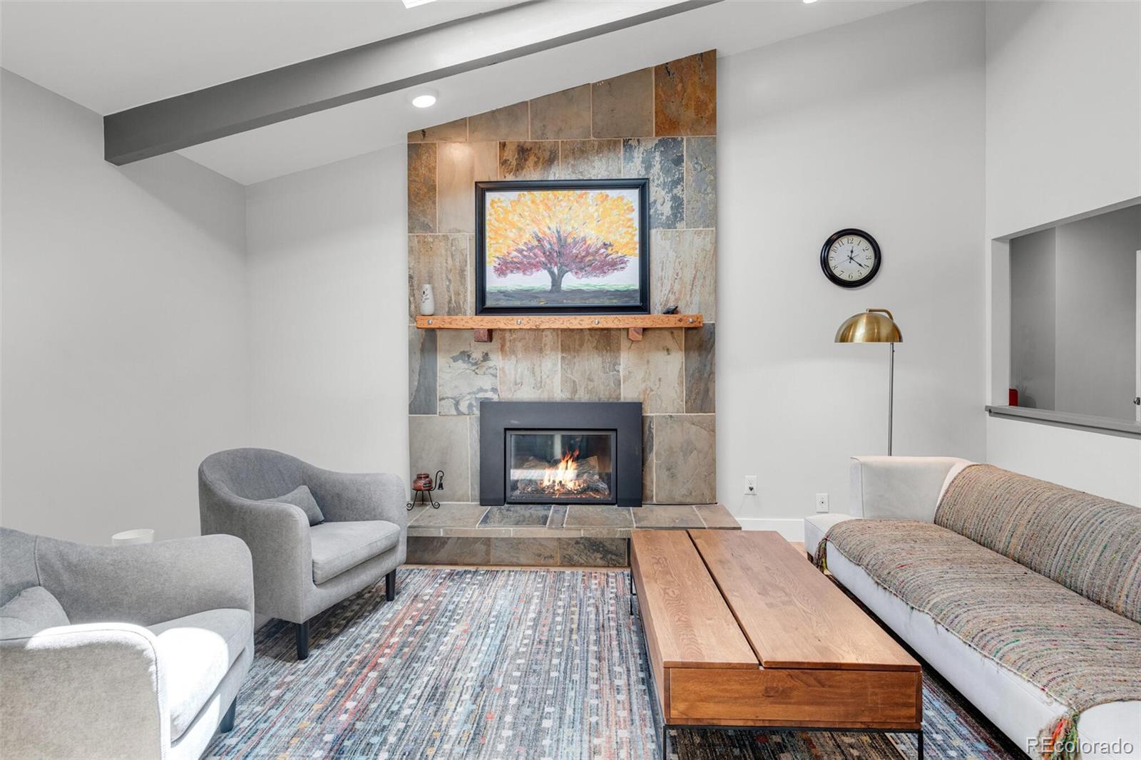 4595 West Lakeridge Road Denver, CO 80219 - Photo 18 of 45 a living room with furniture and a fireplace