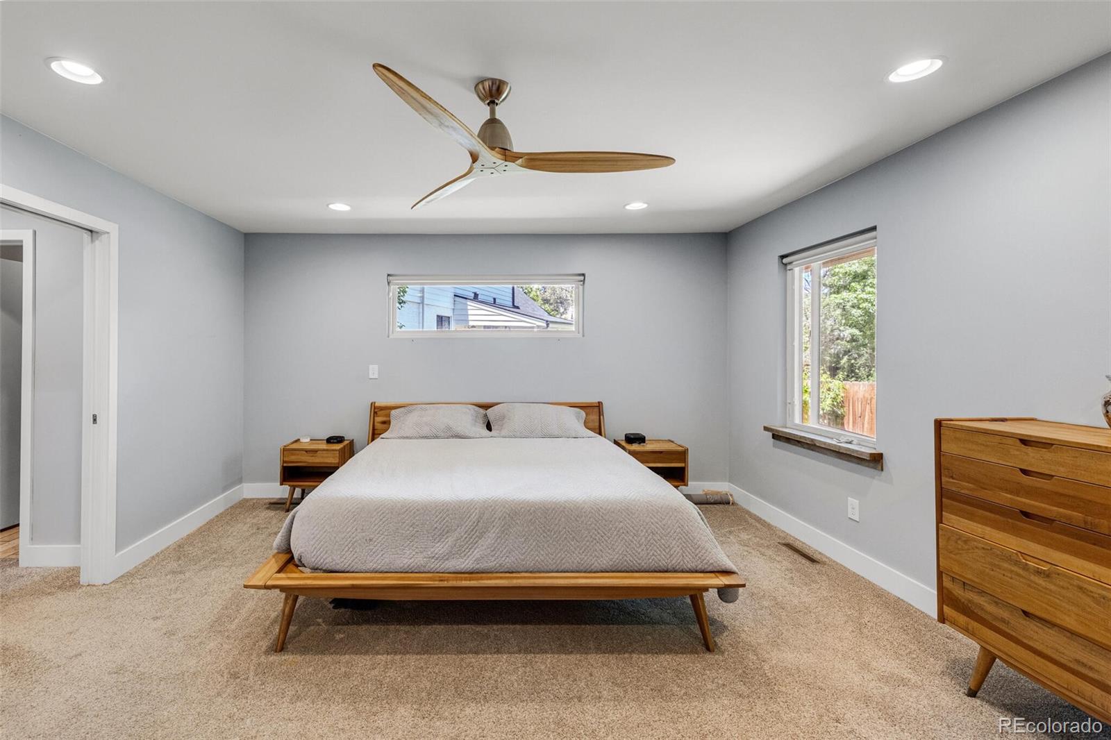 4595 West Lakeridge Road Denver, CO 80219 - Photo 19 of 45 a bedroom with a bed and a dresser