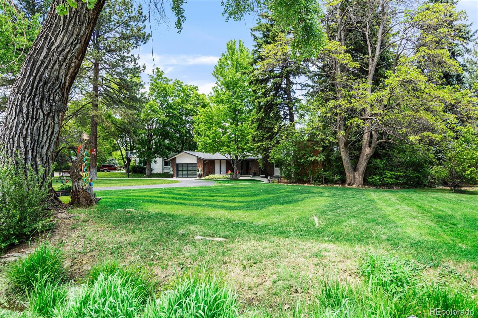 4595 West Lakeridge Road Denver, CO 80219 - Photo 2 of 45 a view of a house with backyard and sitting area