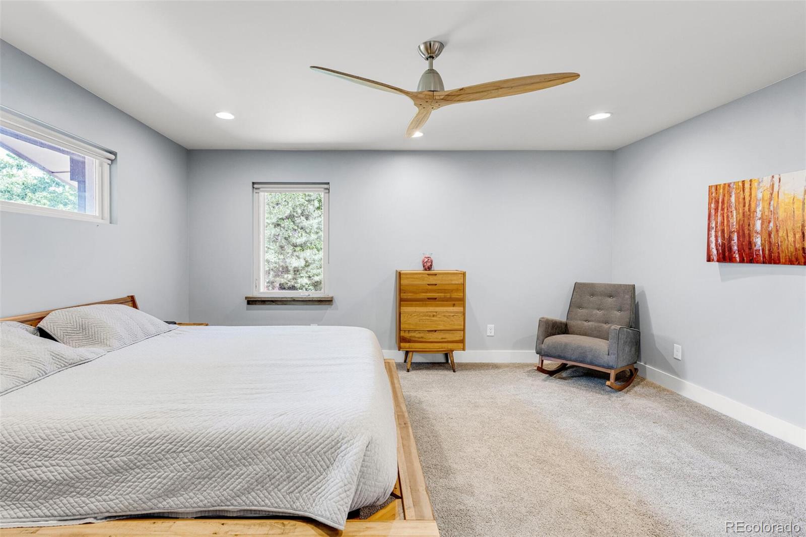 4595 West Lakeridge Road Denver, CO 80219 - Photo 21 of 45 a bedroom with a bed and a couch