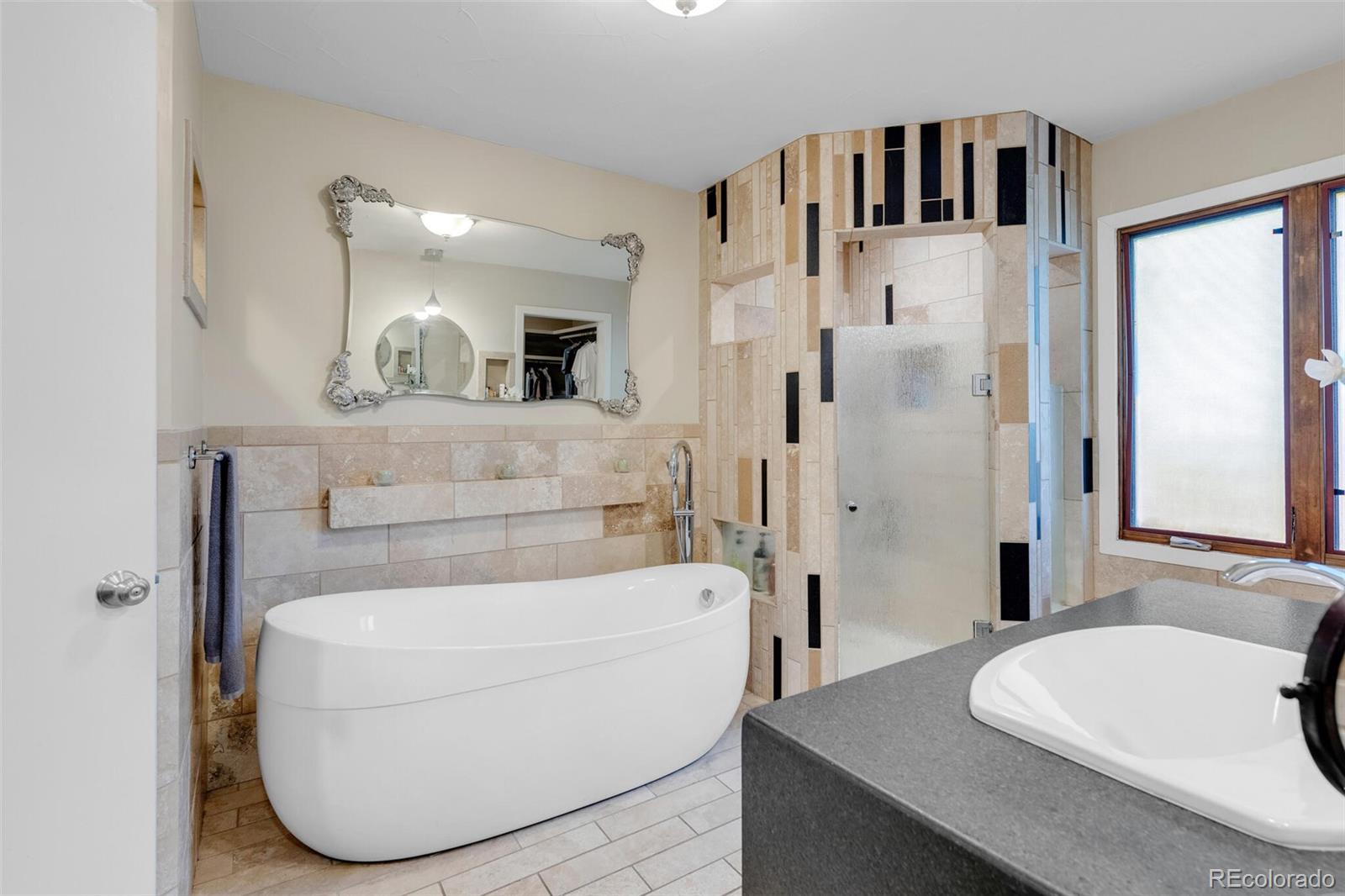 4595 West Lakeridge Road Denver, CO 80219 - Photo 22 of 45 a bathroom with a sink a toilet and shower