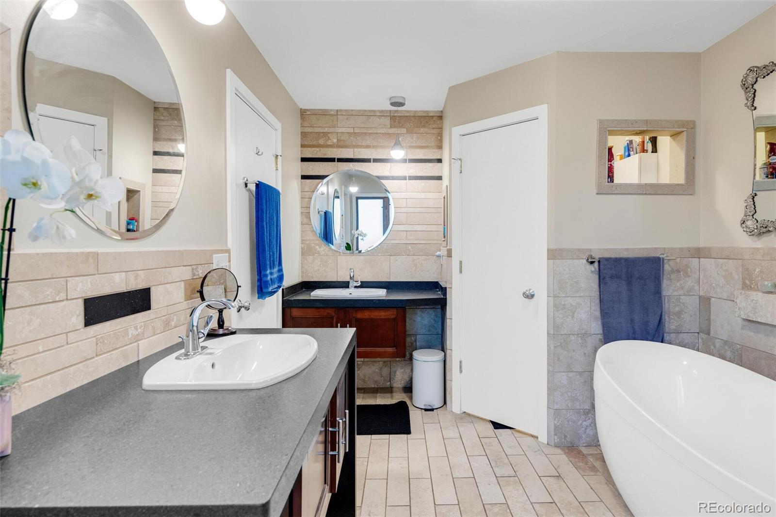 4595 West Lakeridge Road Denver, CO 80219 - Photo 23 of 45 a bathroom with a sink and a mirror