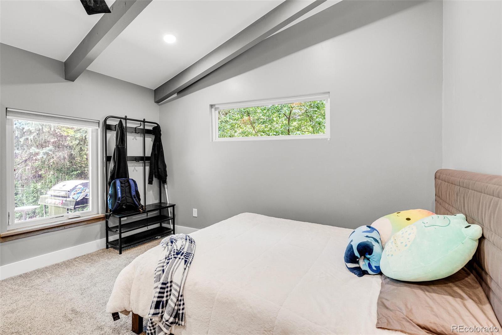 4595 West Lakeridge Road Denver, CO 80219 - Photo 25 of 45 a bedroom with a bed and wooden floor