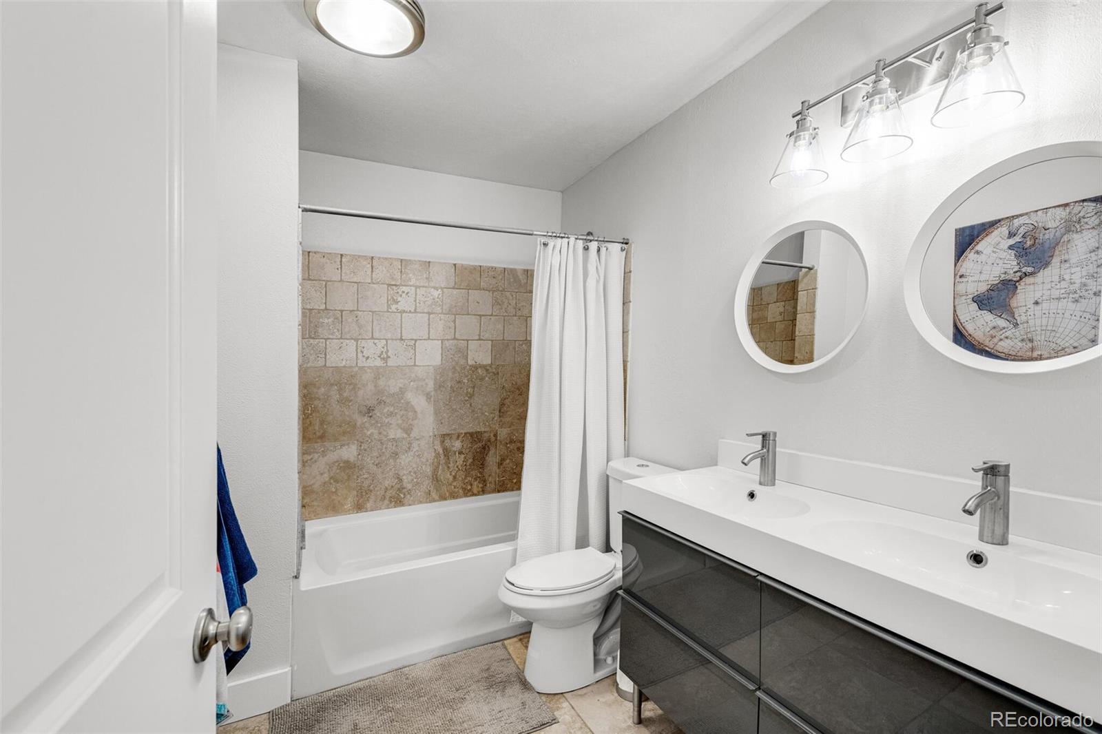 4595 West Lakeridge Road Denver, CO 80219 - Photo 26 of 45 a bathroom with a sink and a mirror