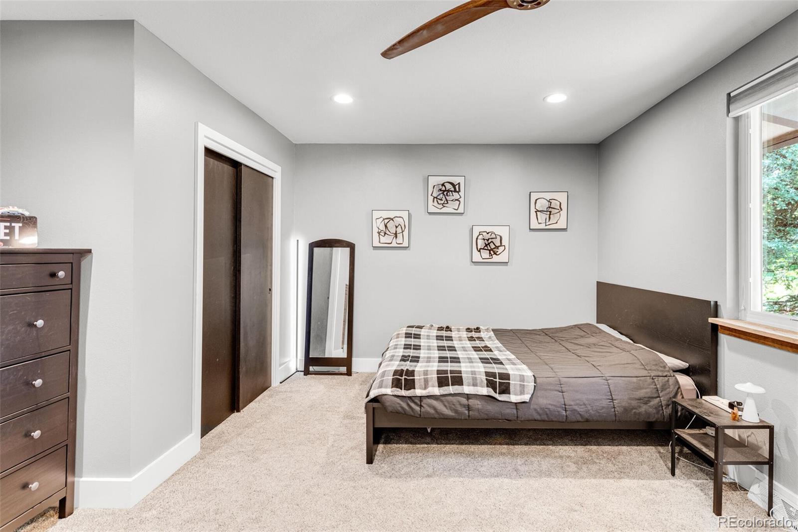 4595 West Lakeridge Road Denver, CO 80219 - Photo 28 of 45 a bedroom with a bed and a window