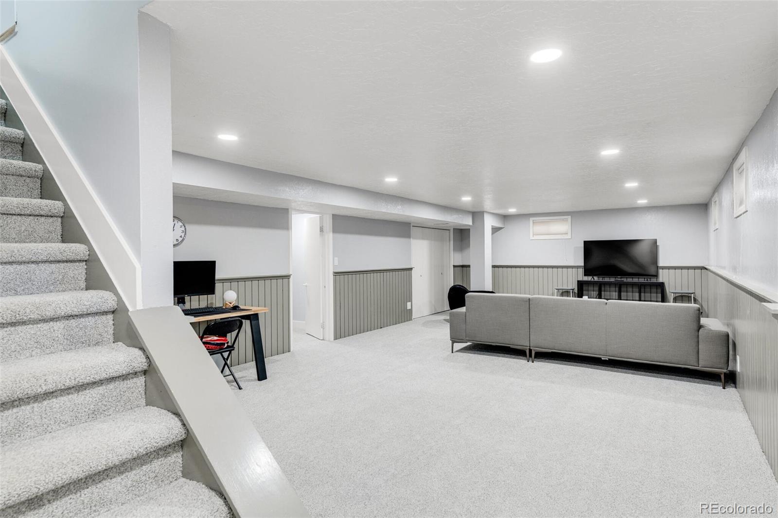 4595 West Lakeridge Road Denver, CO 80219 - Photo 30 of 45 a living room with furniture and a flat screen tv