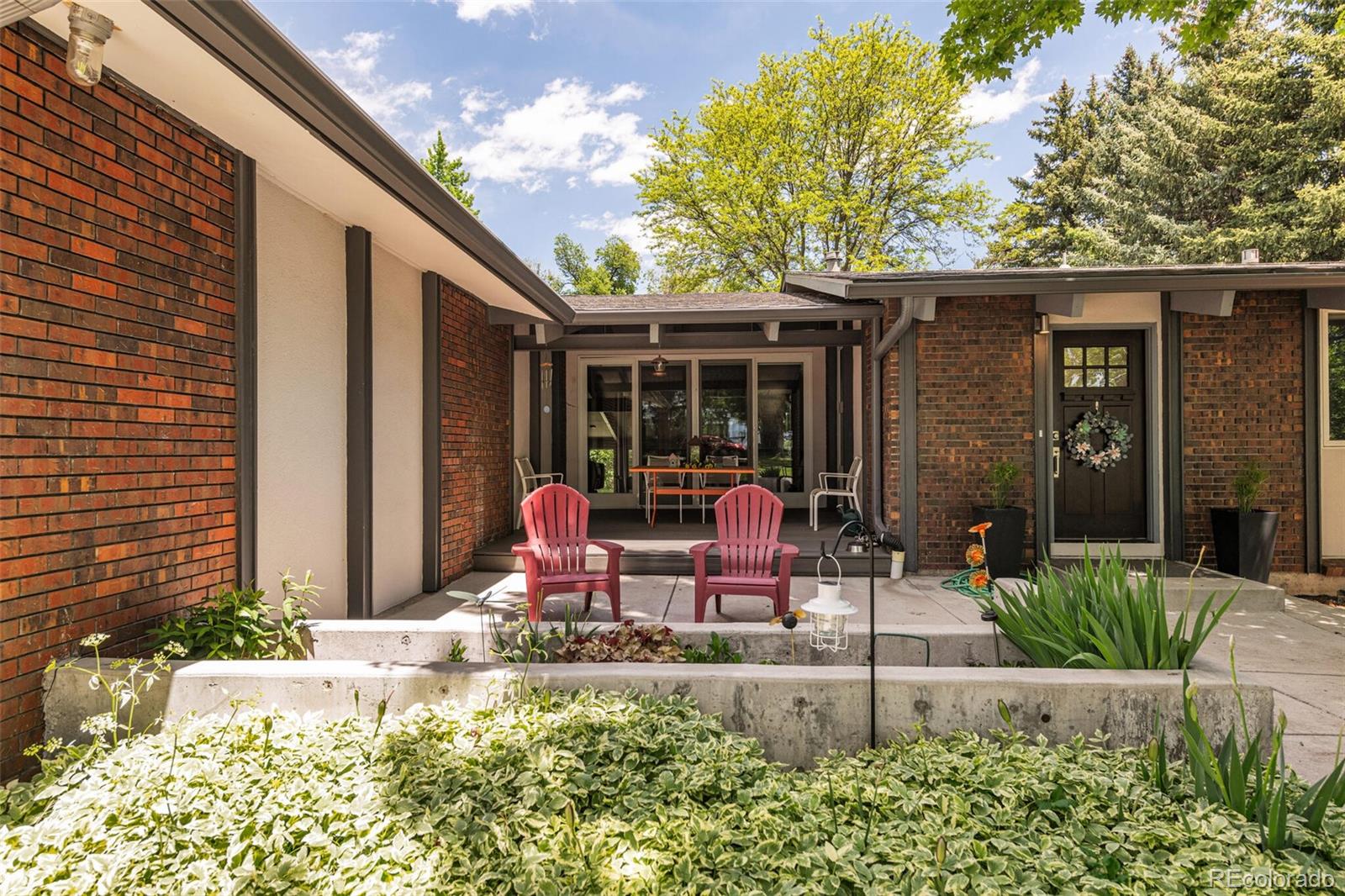 4595 West Lakeridge Road Denver, CO 80219 - Photo 3 of 45 a view of a house with backyard and sitting area