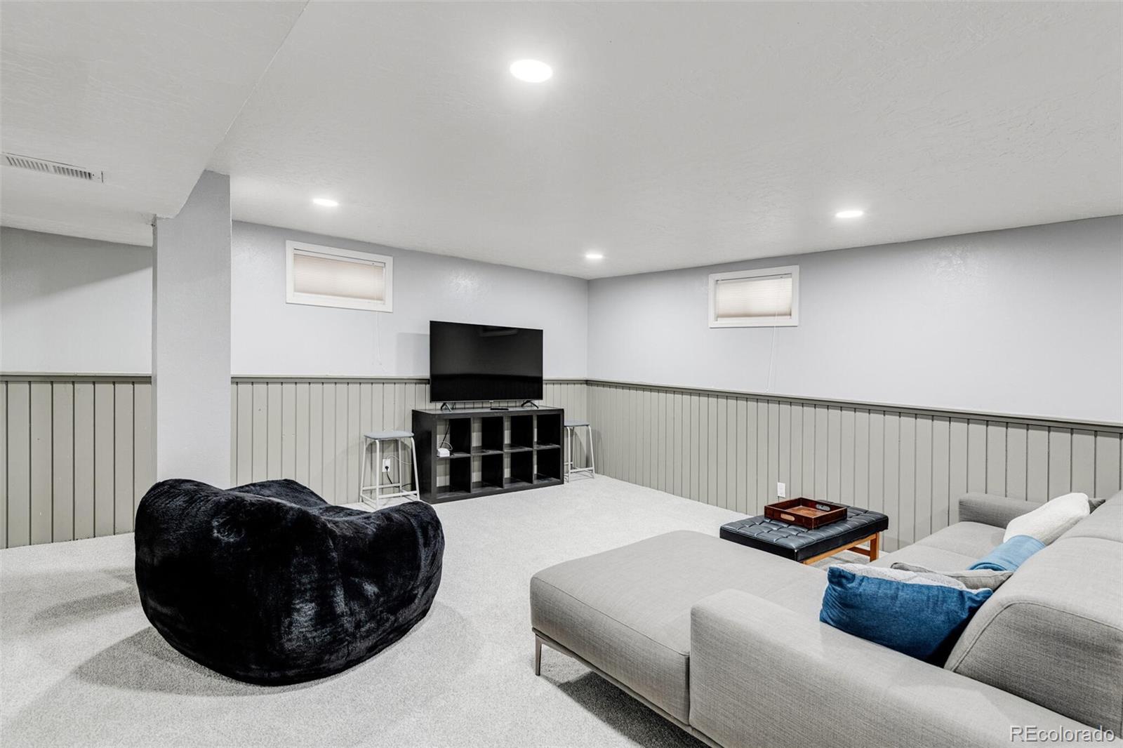 4595 West Lakeridge Road Denver, CO 80219 - Photo 31 of 45 a living room with furniture and a flat screen tv