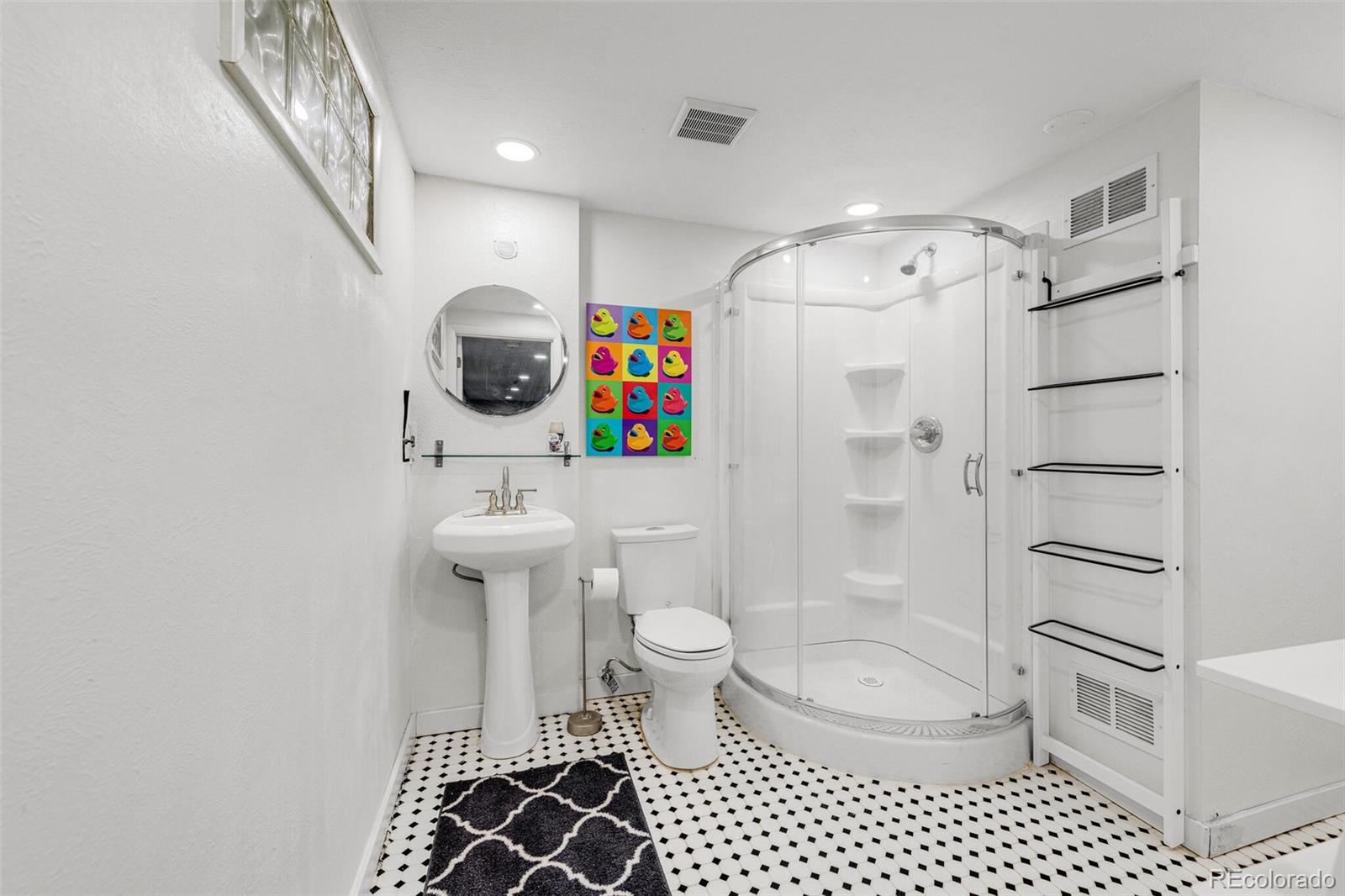 4595 West Lakeridge Road Denver, CO 80219 - Photo 33 of 45 a bathroom with a toilet a sink and a shower