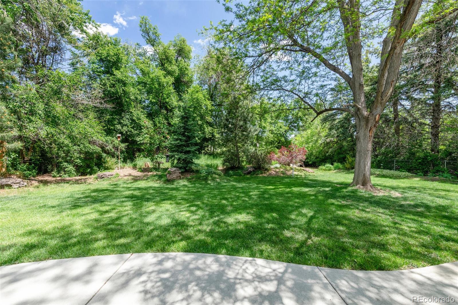 4595 West Lakeridge Road Denver, CO 80219 - Photo 37 of 45 a backyard of a house with lots of green space