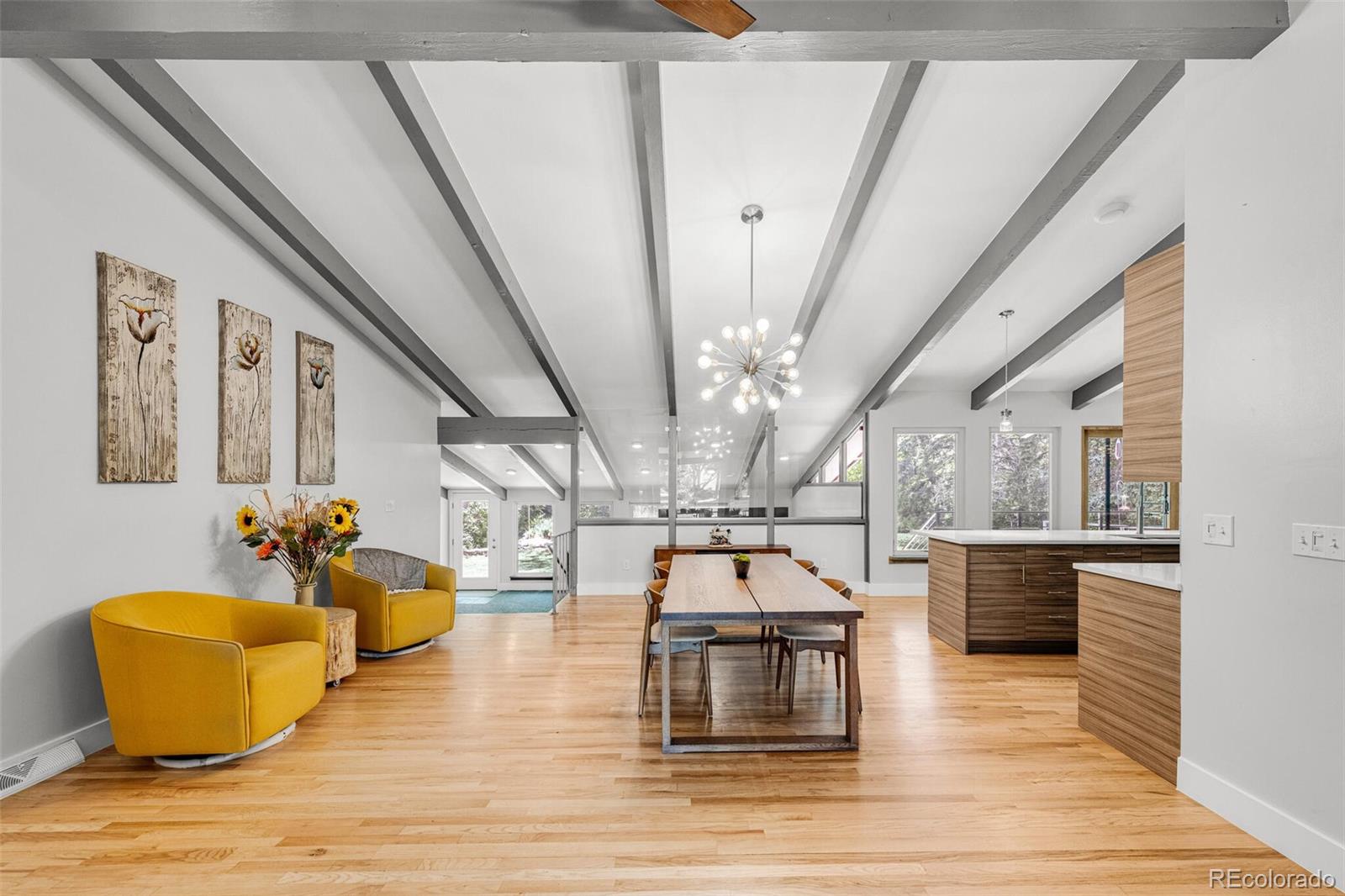 4595 West Lakeridge Road Denver, CO 80219 - Photo 7 of 45 a living room with couches and kitchen view with wooden floor