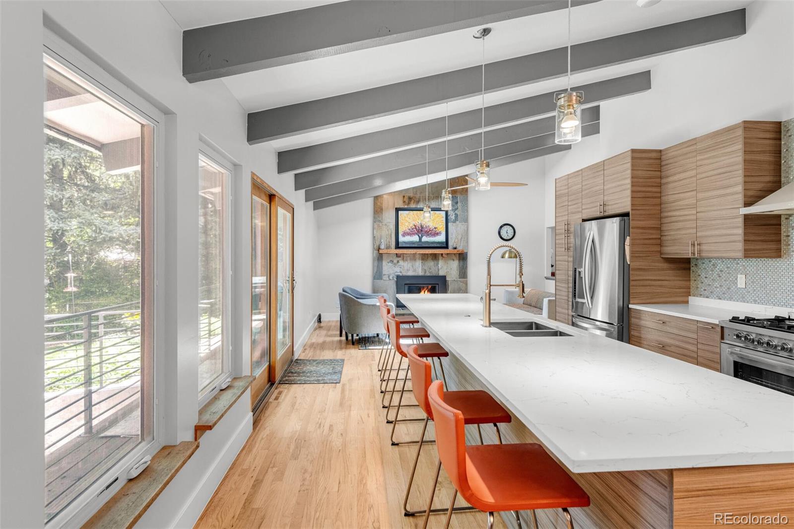 4595 West Lakeridge Road Denver, CO 80219 - Photo 9 of 45 a room with stainless steel appliances kitchen island granite countertop furniture and a large window