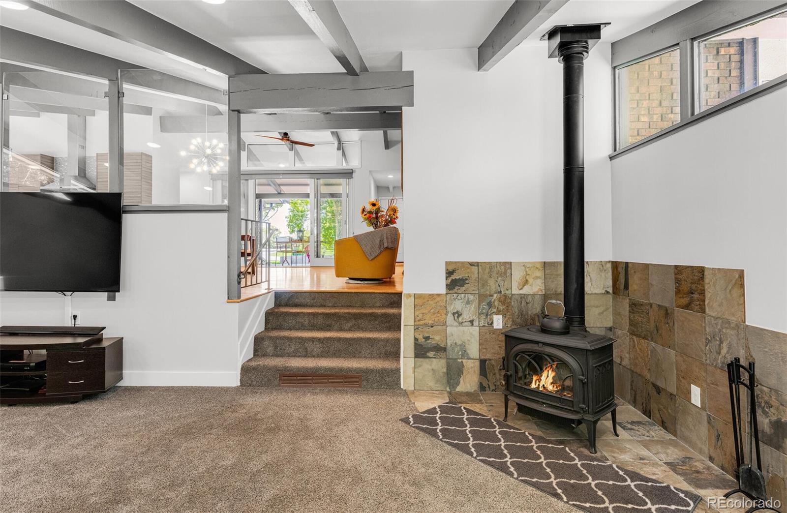 4595 West Lakeridge Road Denver, CO 80219 - Photo 10 of 45 a living room with furniture a flat screen tv and a fireplace