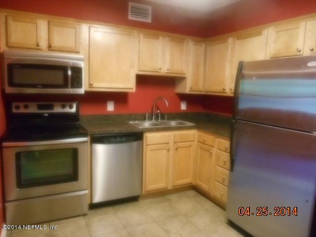 10633 Rutgers Road Jacksonville, FL 32218 - Photo 4 of 11 a kitchen with stainless steel appliances granite countertop a stove a microwave and a refrigerator