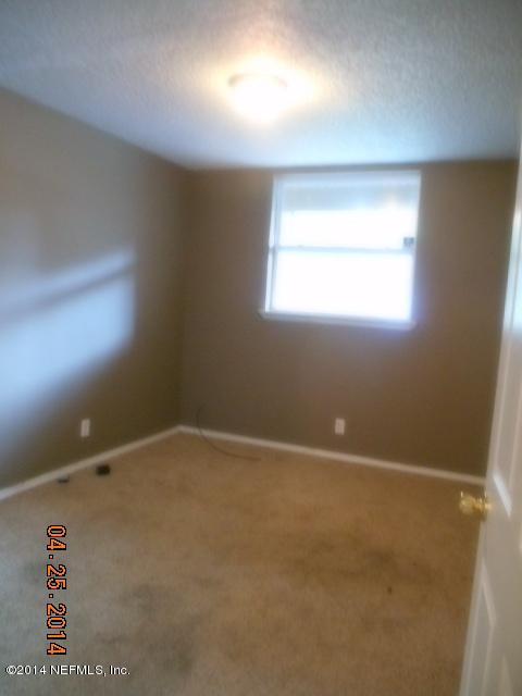 10633 Rutgers Road Jacksonville, FL 32218 - Photo 8 of 11 en empty room with windows
