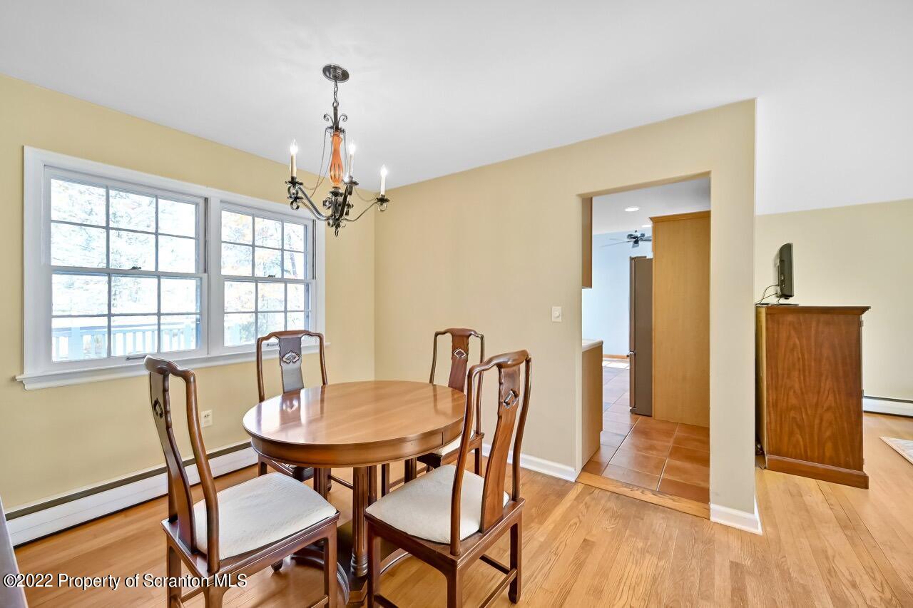 104 Fern Lane Moscow, PA 18444 - Photo 11 of 44 a view of a dining room with furniture window and wooden floor