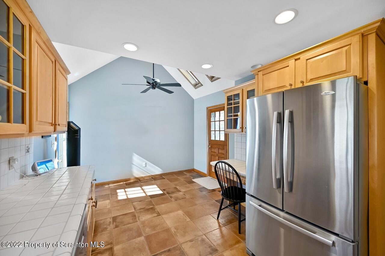 104 Fern Lane Moscow, PA 18444 - Photo 17 of 44 a bathroom with a granite countertop sink and a refrigerator