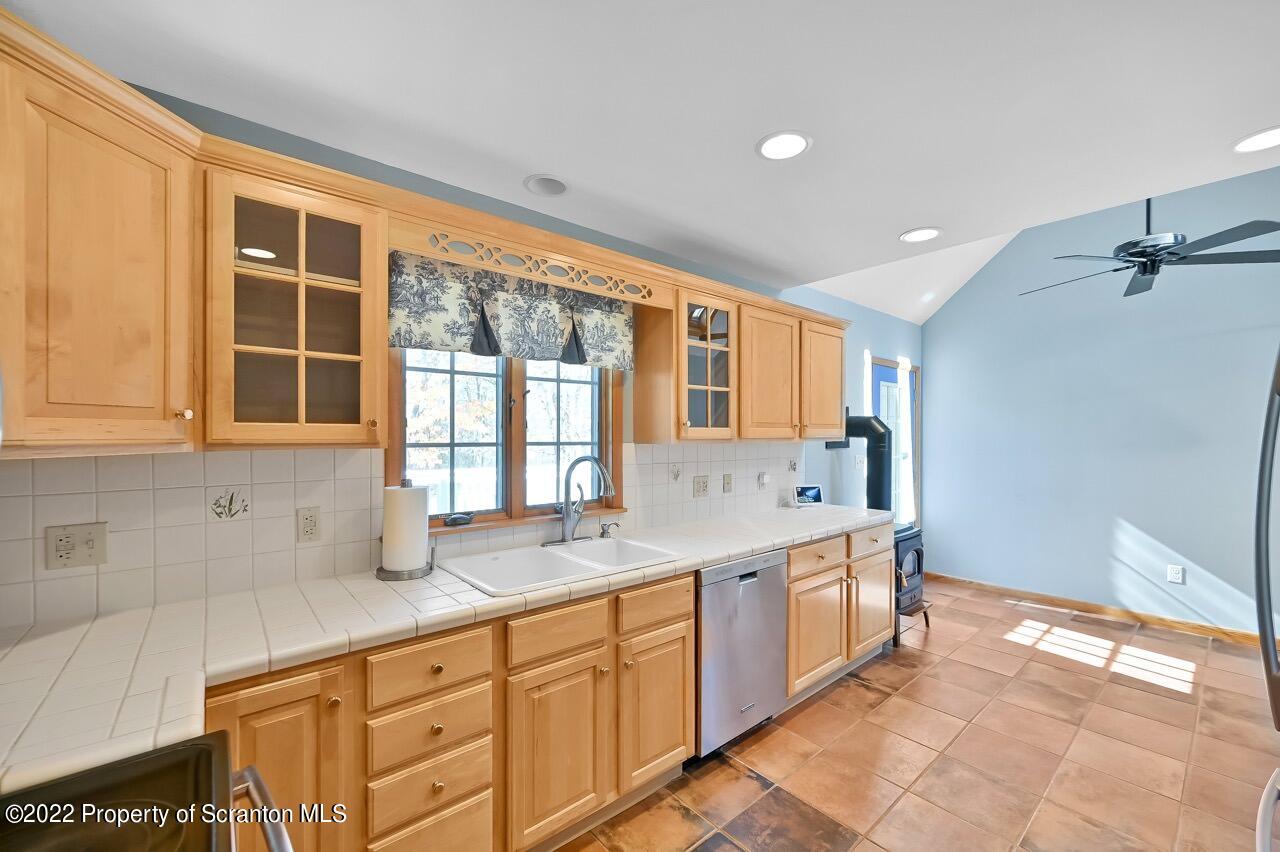 104 Fern Lane Moscow, PA 18444 - Photo 18 of 44 a large kitchen with a sink and cabinets