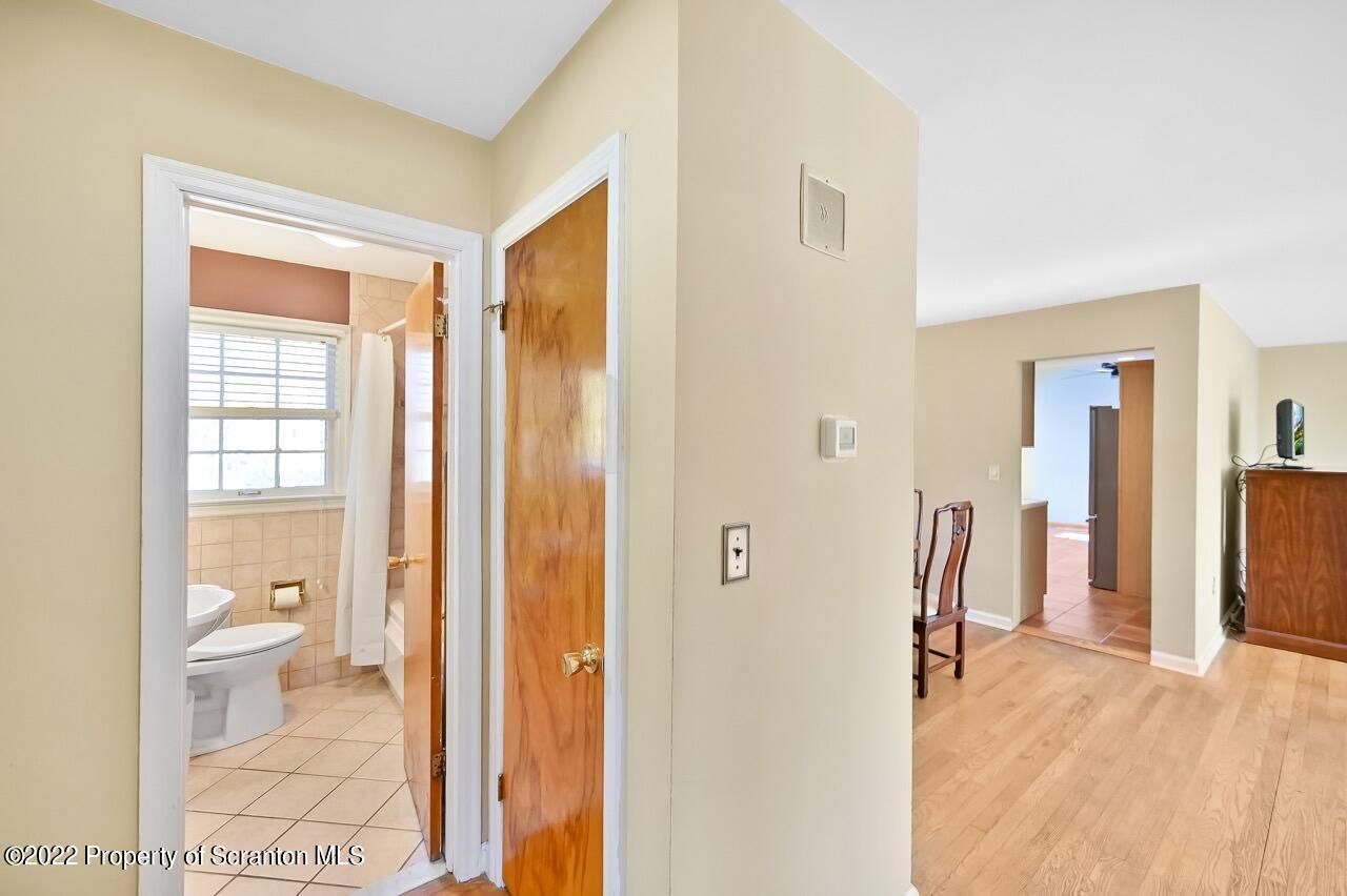 104 Fern Lane Moscow, PA 18444 - Photo 19 of 44 a bathroom with a granite countertop sink a toilet and a shower