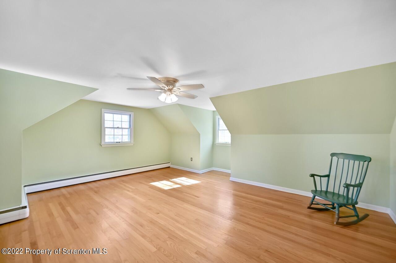 104 Fern Lane Moscow, PA 18444 - Photo 29 of 44 a view of an empty room with a window and wooden floor