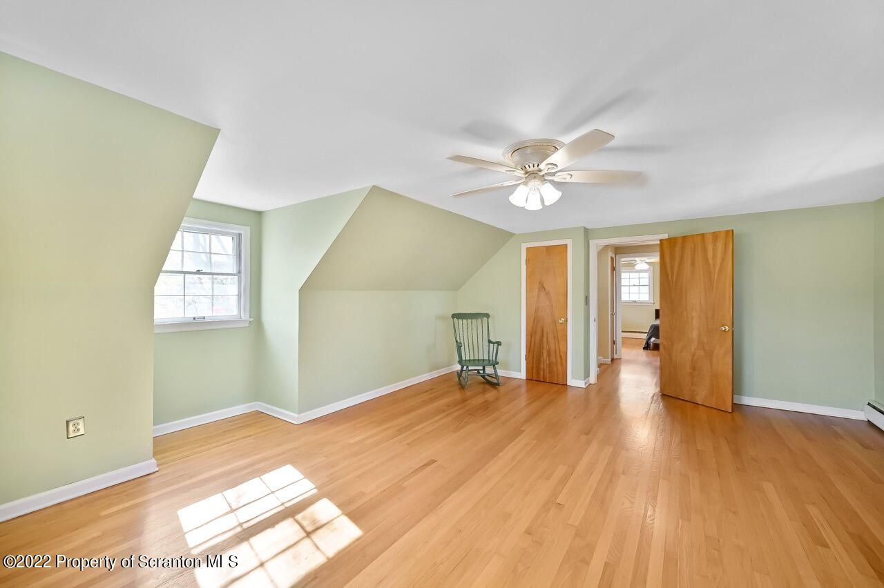 104 Fern Lane Moscow, PA 18444 - Photo 30 of 44 a view of a big room with wooden floor and a ceiling fan