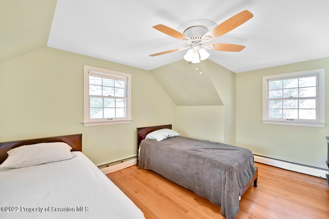 104 Fern Lane Moscow, PA 18444 - Photo 34 of 44 a bedroom with a bed and a chandelier