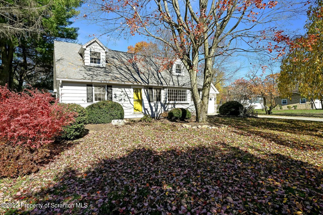 104 Fern Lane Moscow, PA 18444 - Photo 36 of 44 a view of a white house with a yard covered with flower plants
