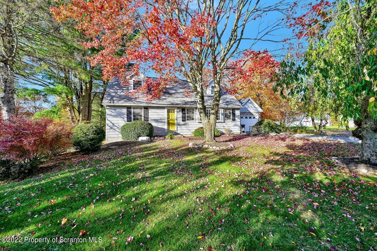104 Fern Lane Moscow, PA 18444 - Photo 38 of 44 a front view of a house with a yard garage and outdoor seating